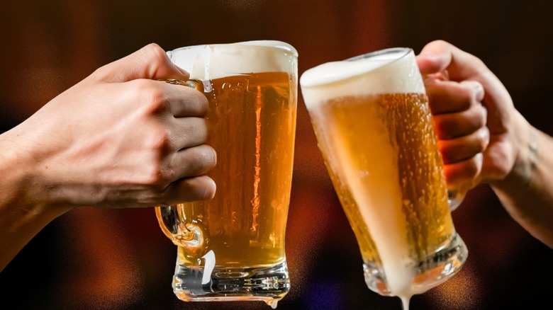 People toasting with beer mugs